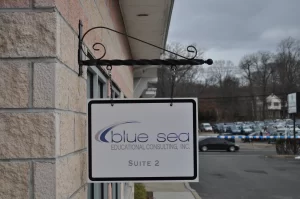 Wayfinding Signs outdoor hanging blade sign blue sea building business wayfinding address sign 300x199